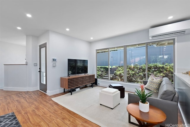 living room with wood-type flooring and a wall mounted AC