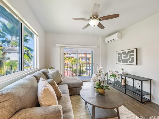 living room featuring hardwood / wood-style flooring, ceiling fan, and a wall unit AC