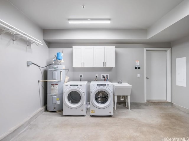 washroom featuring secured water heater, cabinets, and independent washer and dryer