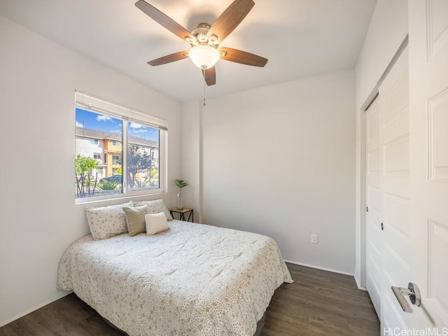 bedroom with dark wood-type flooring and ceiling fan