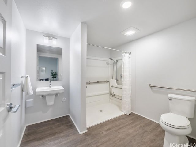 bathroom with sink, a shower with curtain, wood-type flooring, and toilet