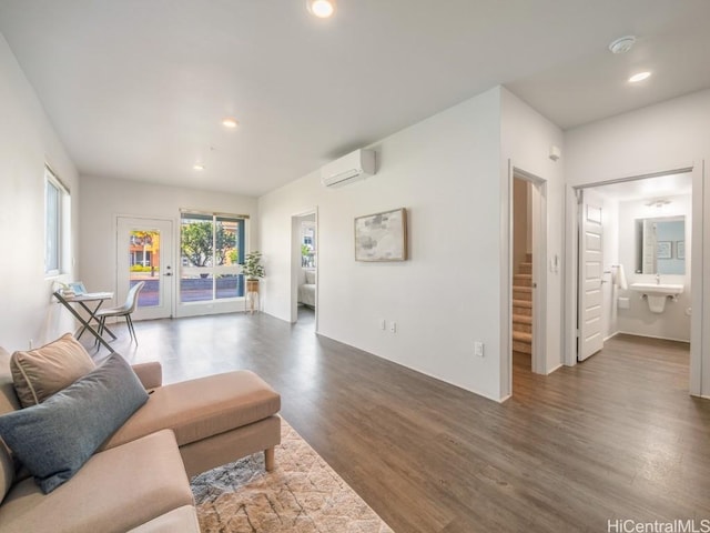 living room featuring dark hardwood / wood-style flooring, sink, and an AC wall unit