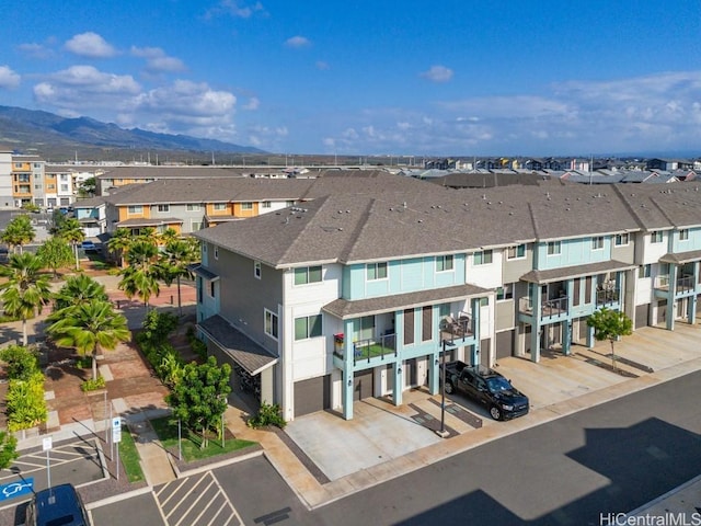 birds eye view of property with a mountain view