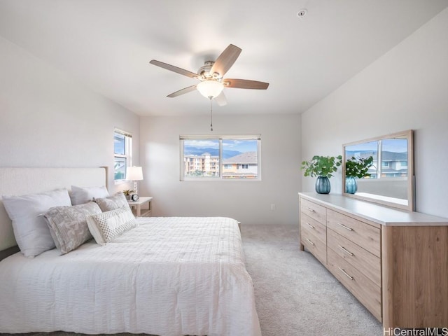 bedroom with ceiling fan and light colored carpet