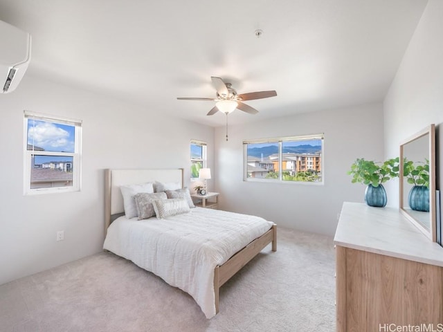 carpeted bedroom featuring a wall mounted air conditioner and ceiling fan