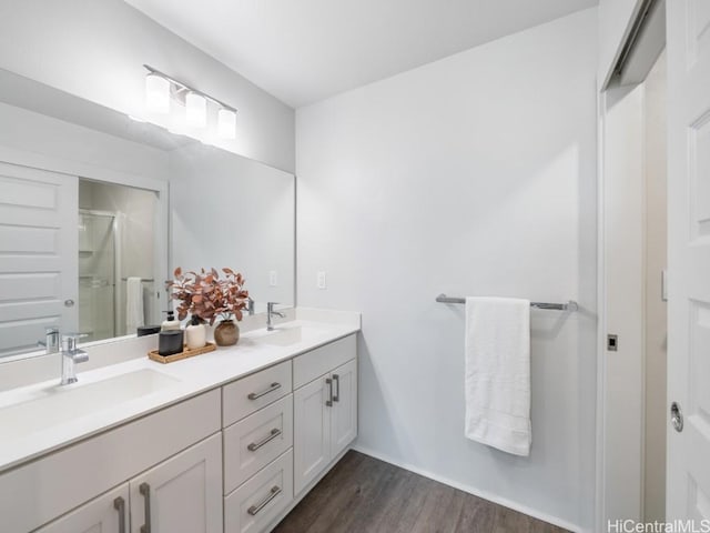 bathroom featuring vanity, a shower with shower door, and hardwood / wood-style floors