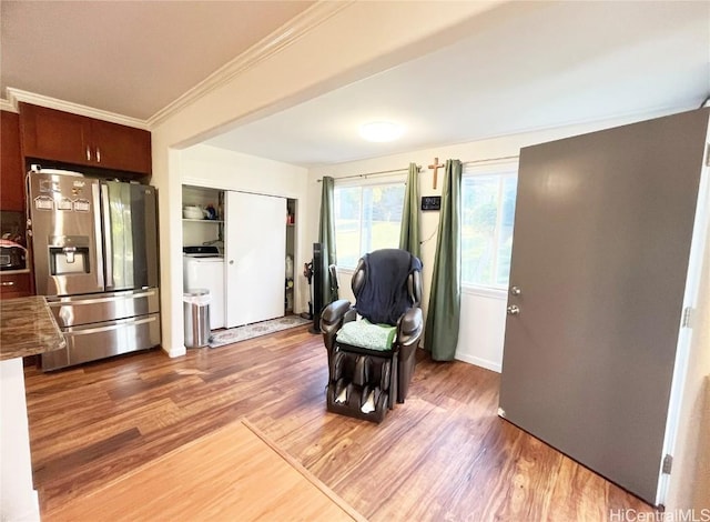 living area featuring crown molding and hardwood / wood-style flooring