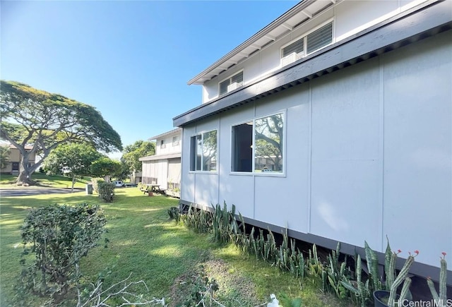 view of side of home featuring a lawn