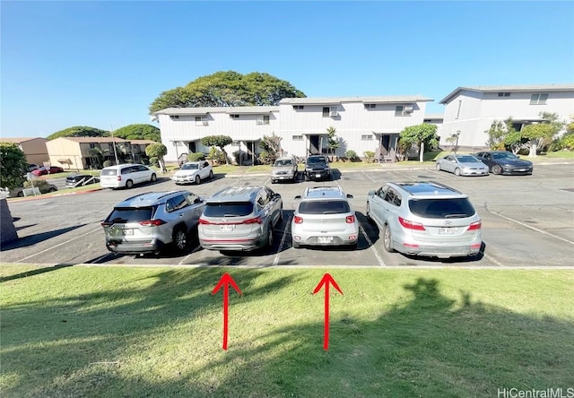 view of car parking with a yard