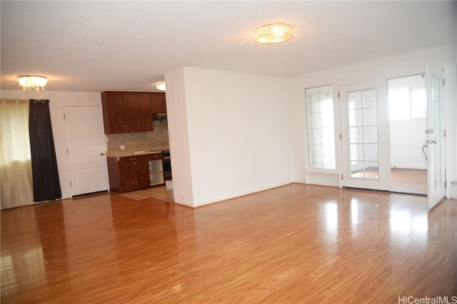 unfurnished living room with light wood-type flooring