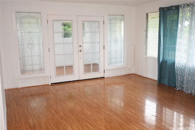 interior space featuring french doors, wood-type flooring, and a wealth of natural light