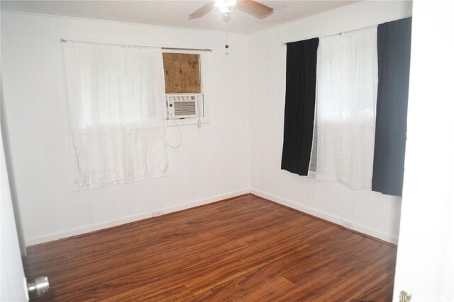 spare room with dark wood-type flooring, ceiling fan, and cooling unit