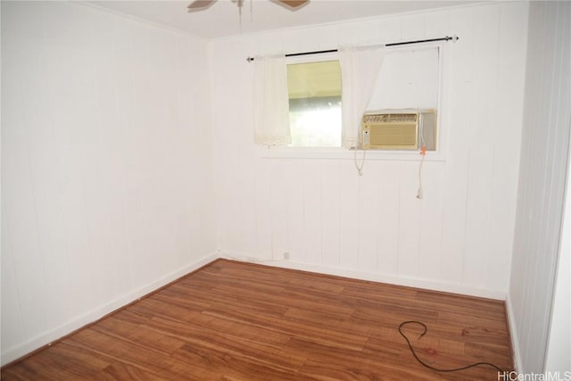 spare room featuring hardwood / wood-style flooring, ceiling fan, crown molding, and cooling unit