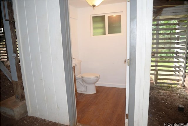 bathroom with toilet and hardwood / wood-style floors