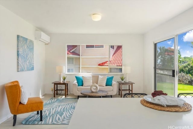 living area featuring an AC wall unit and light hardwood / wood-style flooring