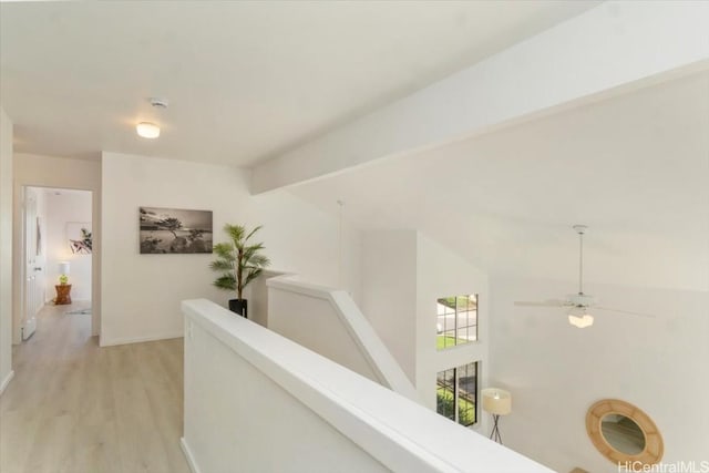 hall with vaulted ceiling with beams and light hardwood / wood-style flooring