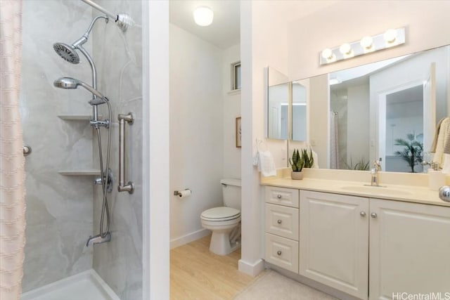 bathroom featuring vanity, toilet, hardwood / wood-style floors, and walk in shower