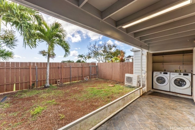 view of yard featuring ac unit and washer and dryer