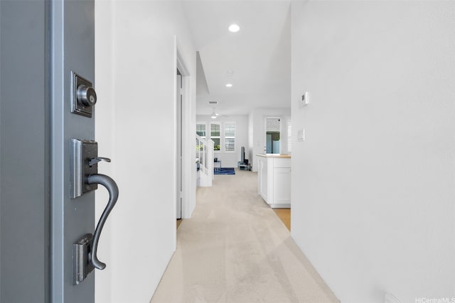 hall featuring recessed lighting and light colored carpet