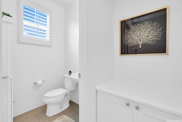 bathroom with tile patterned flooring and toilet