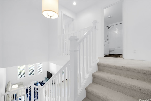 staircase featuring visible vents and recessed lighting