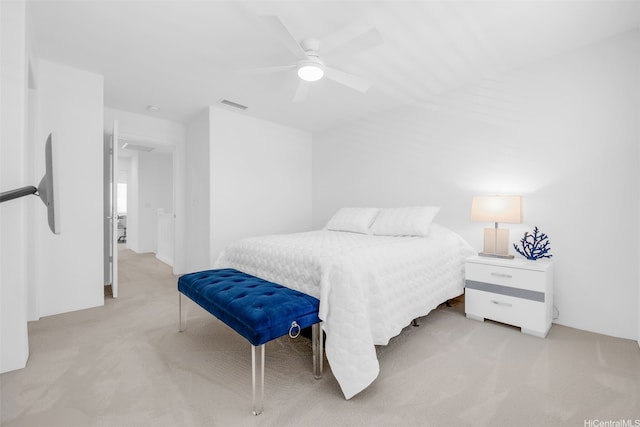 bedroom with light carpet, a ceiling fan, and visible vents