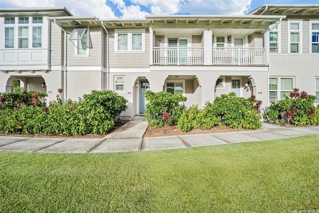 view of property with a front yard and stucco siding