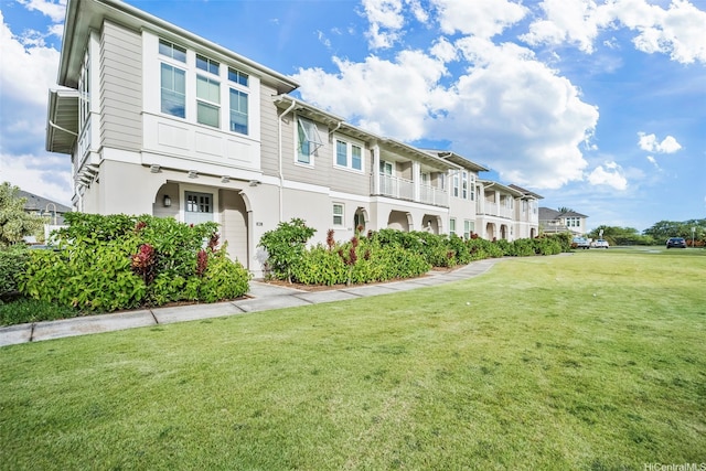 exterior space with a lawn, a residential view, and stucco siding