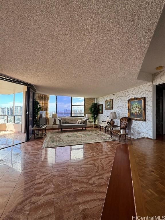 unfurnished living room featuring expansive windows and a textured ceiling