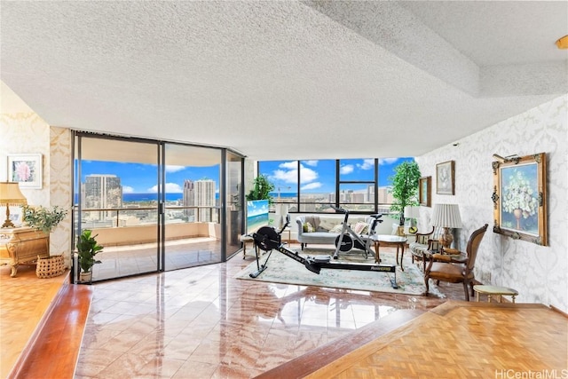 1221 Victoria St Unit 3201, Honolulu, HI 96814 - living area with expansive windows, a city view, a textured ceiling, and wallpapered walls