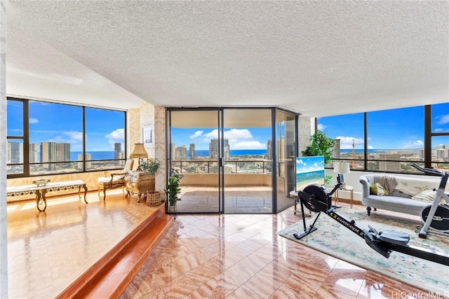 1221 Victoria St Unit 3201, Honolulu, HI 96814 - living area featuring expansive windows, marble finish floor, a textured ceiling, and a healthy amount of sunlight