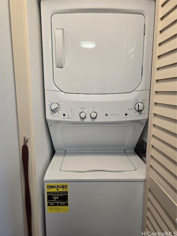 clothes washing area featuring stacked washer and dryer