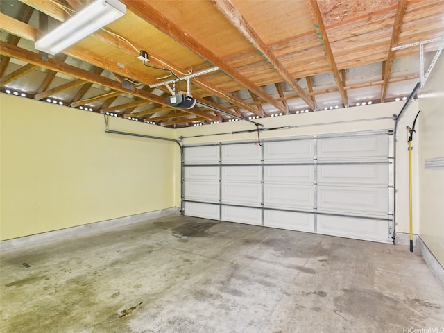 garage featuring baseboards and a garage door opener