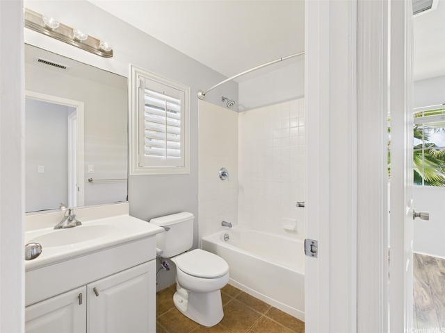 full bath with visible vents, toilet,  shower combination, vanity, and tile patterned flooring