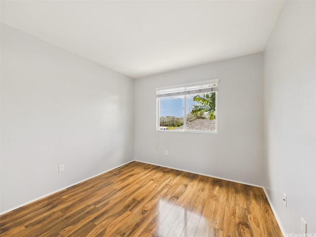 empty room with wood finished floors