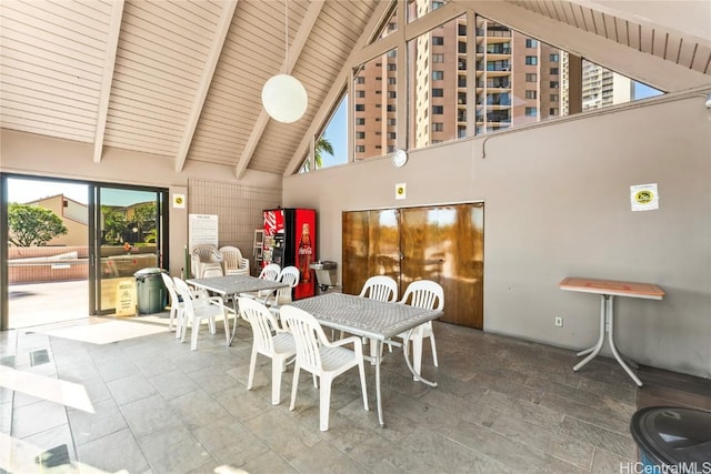 dining room featuring high vaulted ceiling, beam ceiling, and wooden ceiling