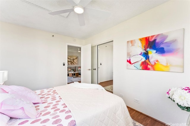 bedroom featuring ceiling fan, a closet, and wood finished floors