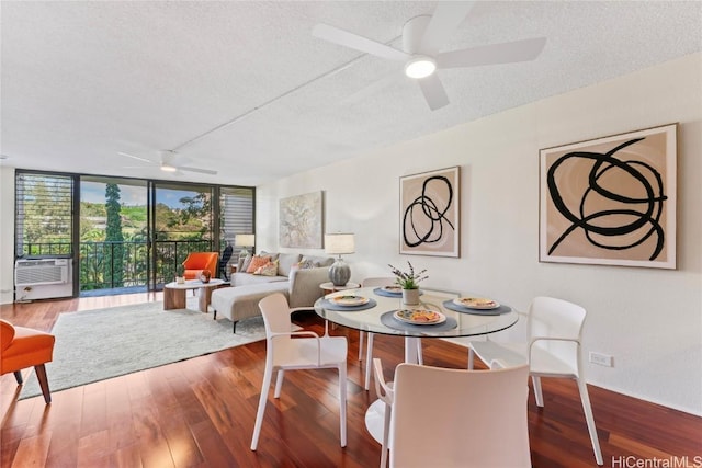 dining space with ceiling fan, wood finished floors, cooling unit, a textured ceiling, and floor to ceiling windows