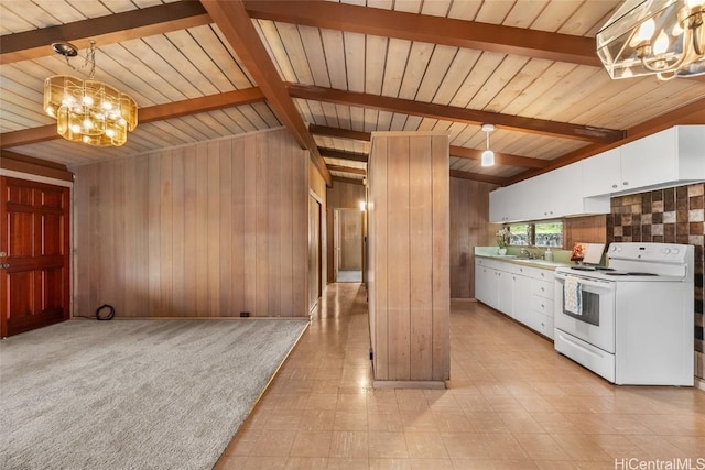 kitchen with white electric range, wood walls, decorative light fixtures, white cabinetry, and beam ceiling