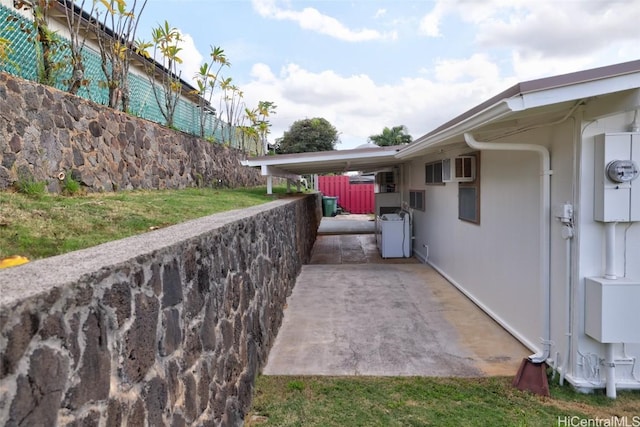 view of patio featuring an AC wall unit