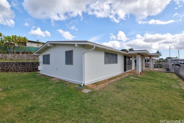 rear view of property with a yard