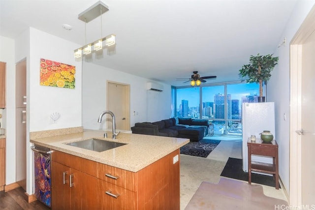 kitchen with an AC wall unit, sink, hanging light fixtures, stainless steel dishwasher, and floor to ceiling windows