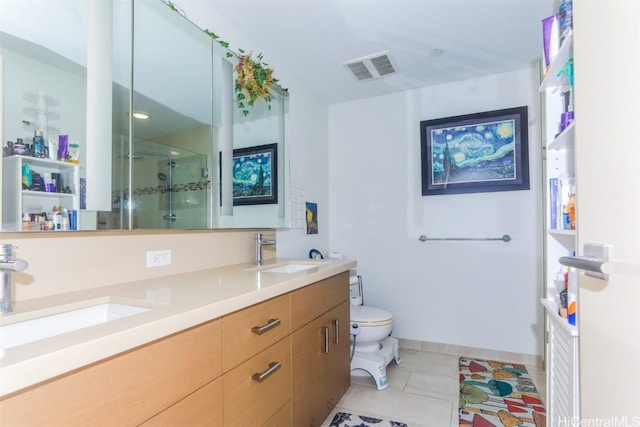 bathroom featuring tile patterned floors, vanity, toilet, and a shower with door