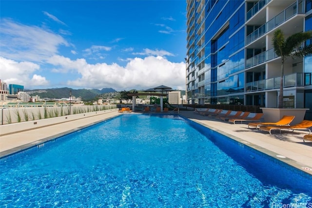 view of pool featuring a mountain view, a gazebo, and a patio