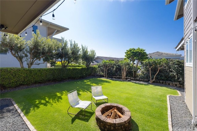 view of yard with a fire pit