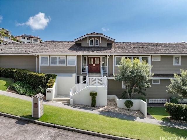 view of front facade featuring a front yard and french doors