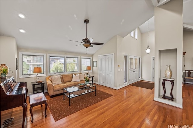 living room featuring high vaulted ceiling, hardwood / wood-style floors, and ceiling fan