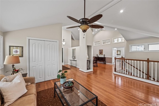 living room featuring high vaulted ceiling and hardwood / wood-style floors