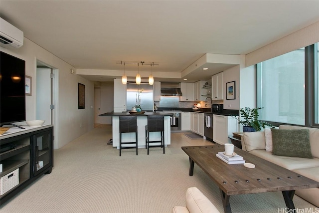 living area featuring light carpet and a wall mounted AC