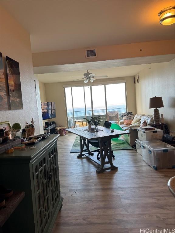 dining space featuring ceiling fan and dark hardwood / wood-style flooring